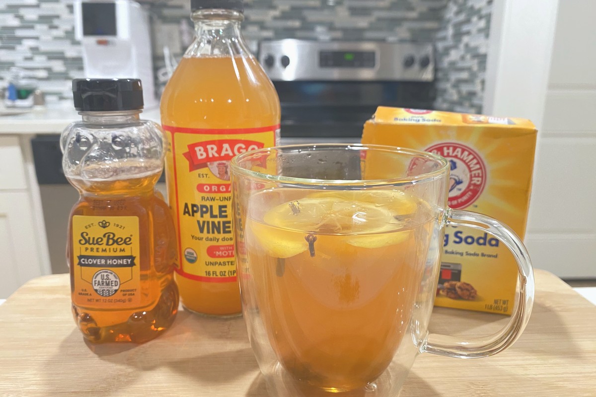 A glass of homemade herbal tea on a kitchen counter